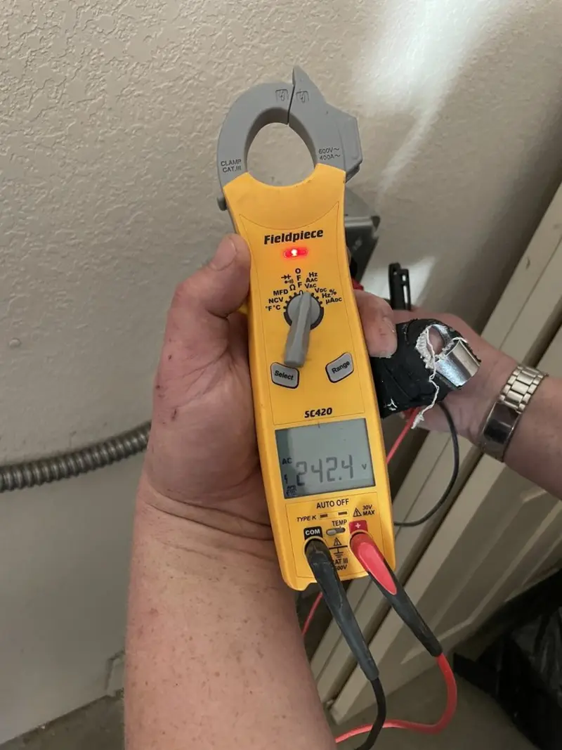 Voltage testing with clamp meter during Ceiling Fan Installation in Brambleton